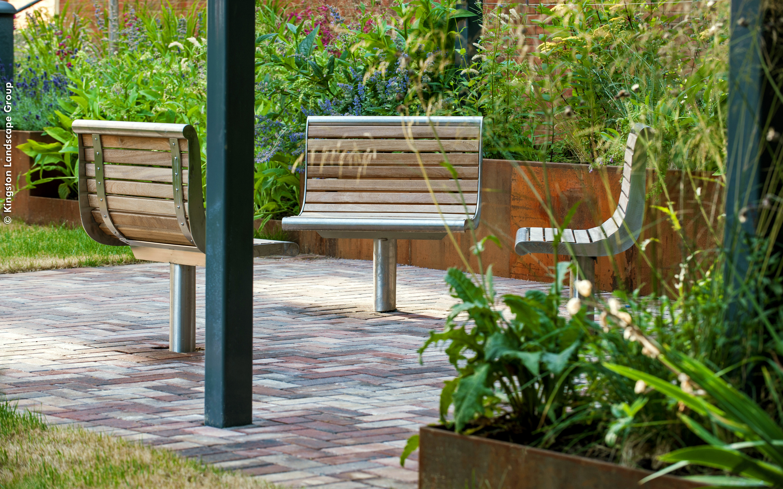 Three seats arranged in a circle and surrounded by greenery